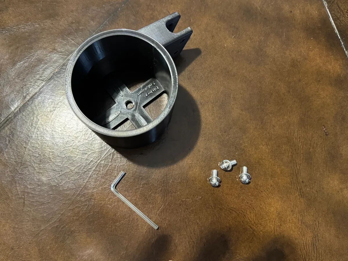 The whole kit: one printed part and three M6 × 12 cap screws — Disher Solutions mark in the base